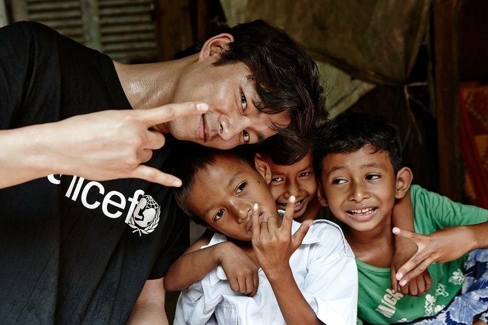 Founder & President Kim Seok-woo smiling with children during field outreach