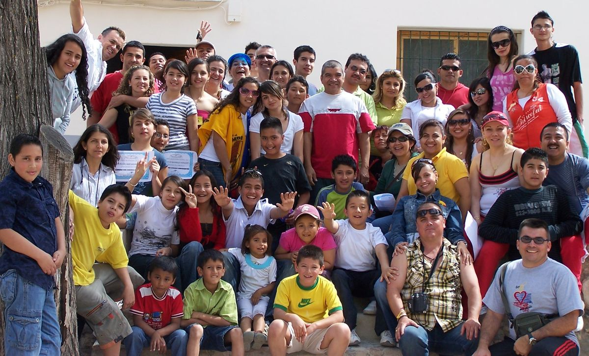 Hundreds of community volunteers, families, and children gathered together outdoors
